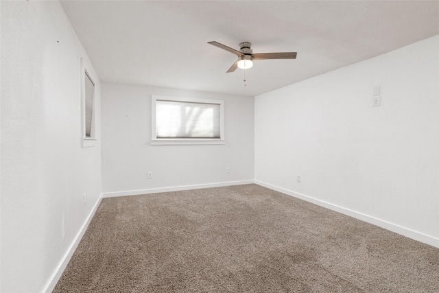 empty room featuring ceiling fan and carpet floors