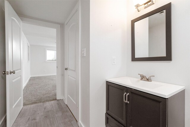 bathroom featuring hardwood / wood-style flooring and vanity