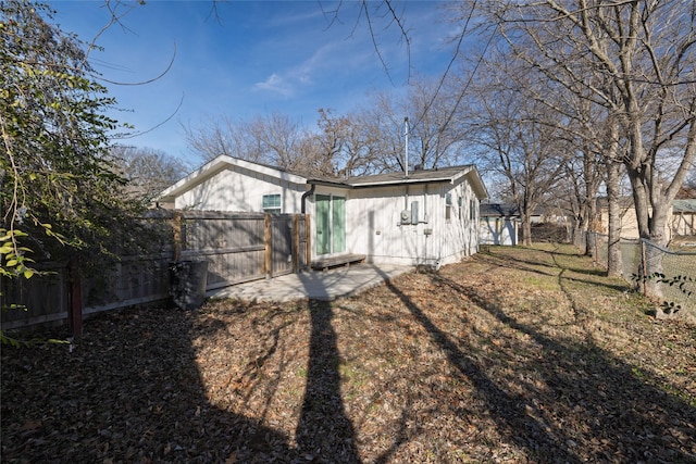 rear view of house with a yard