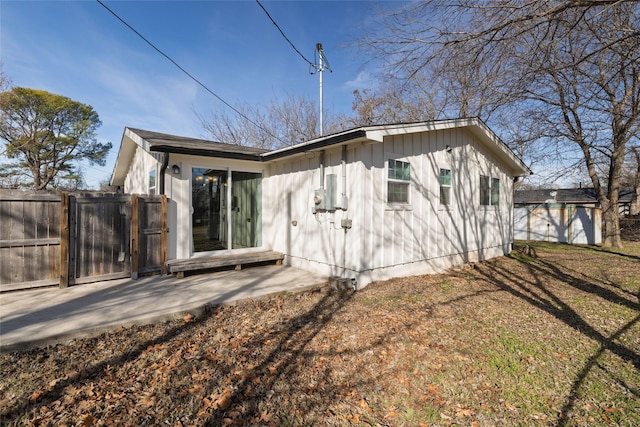 back of house with a yard and a patio