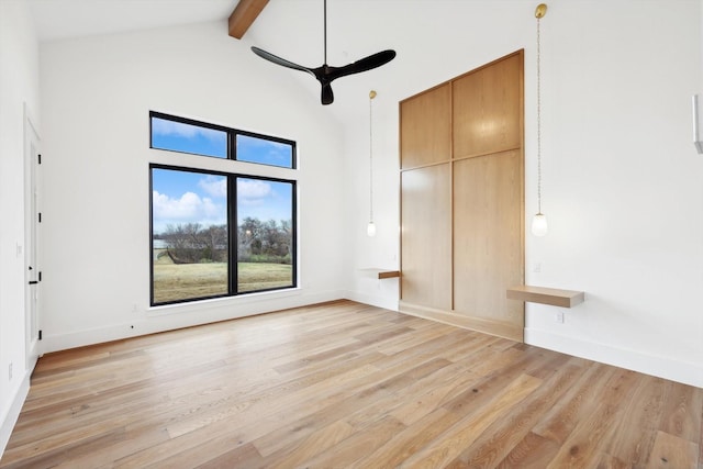 unfurnished bedroom with ceiling fan, light hardwood / wood-style floors, and vaulted ceiling with beams