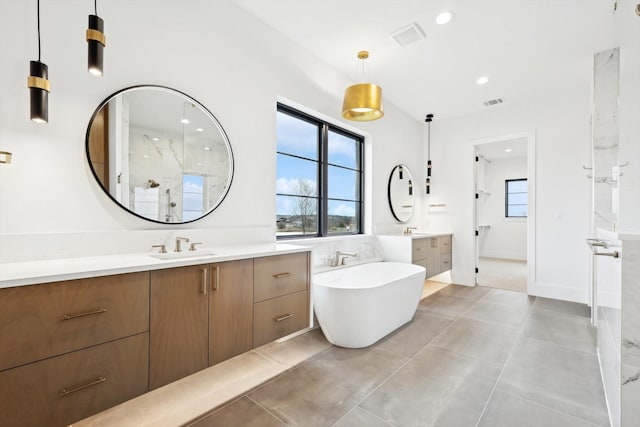 bathroom featuring vanity and independent shower and bath