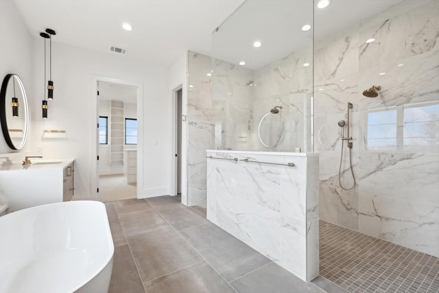 bathroom with vanity and shower with separate bathtub