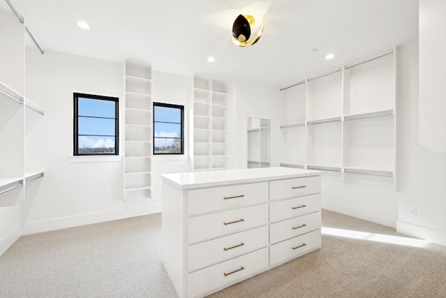 walk in closet featuring light colored carpet