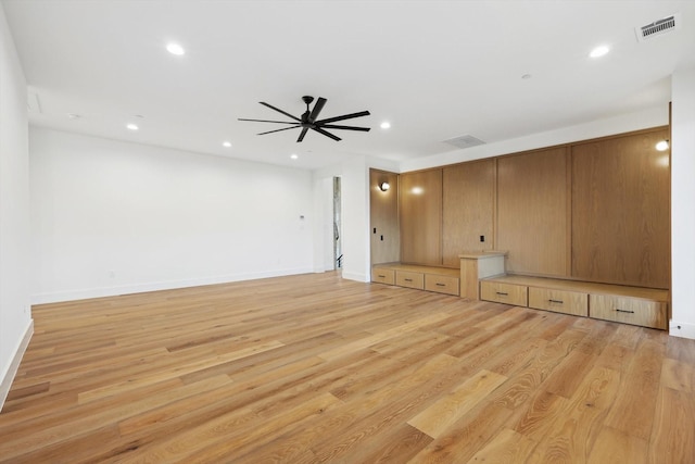 unfurnished living room featuring light wood-type flooring and ceiling fan