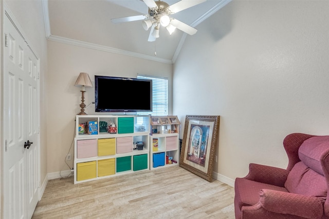 sitting room with crown molding, lofted ceiling, wood-type flooring, and ceiling fan