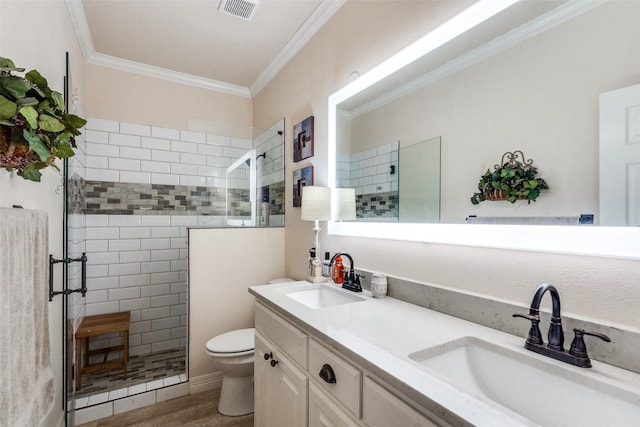 bathroom with wood-type flooring, vanity, tiled shower, toilet, and crown molding