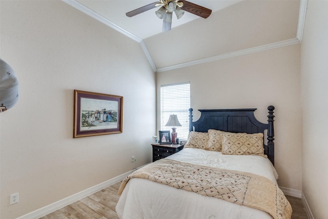 bedroom featuring lofted ceiling, hardwood / wood-style floors, ornamental molding, and ceiling fan