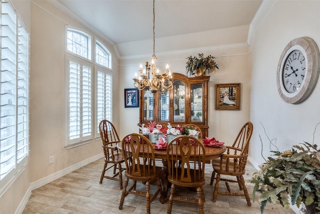 dining room with crown molding, lofted ceiling, light wood-type flooring, and a chandelier