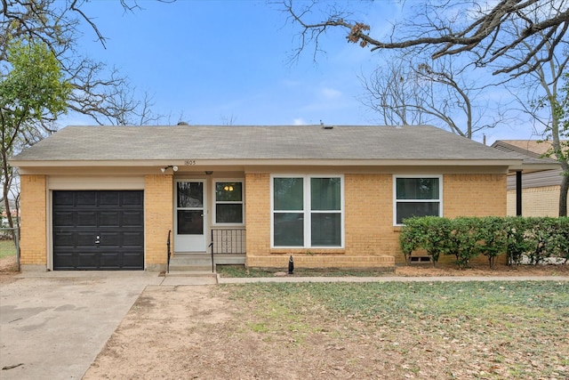 single story home featuring a garage, entry steps, concrete driveway, and brick siding