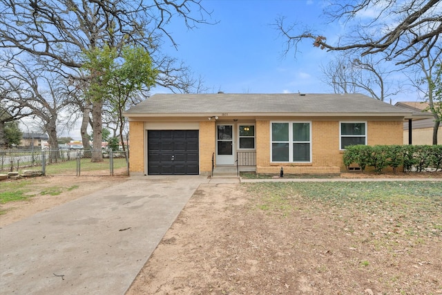 ranch-style house featuring an attached garage, fence, concrete driveway, and brick siding