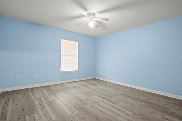 empty room featuring ceiling fan and light wood-type flooring