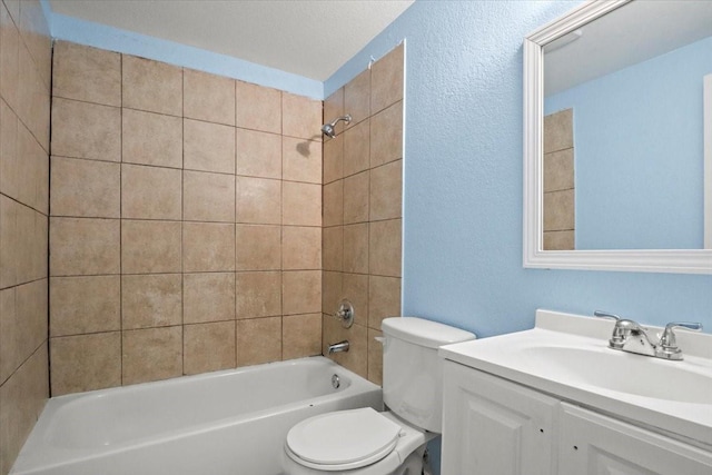 full bathroom with toilet, vanity, and tiled shower / bath