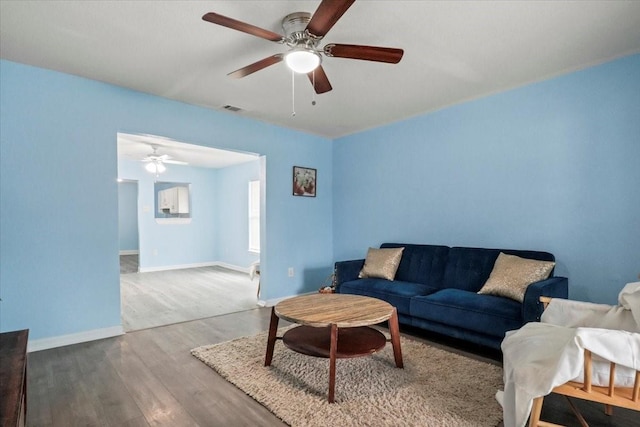 living room with ceiling fan and wood-type flooring