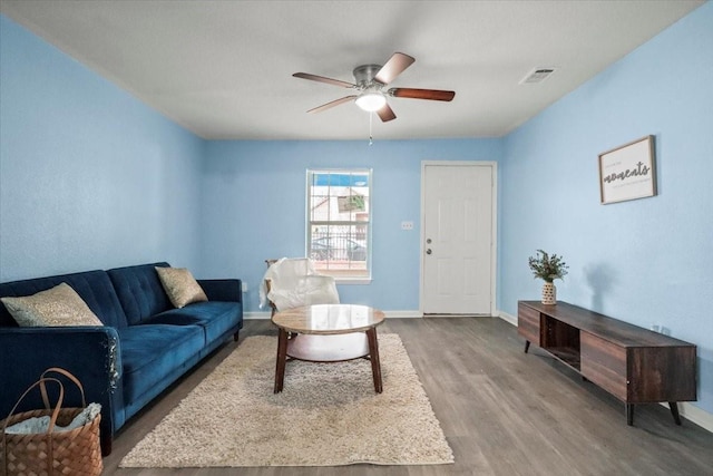 living room with ceiling fan and hardwood / wood-style flooring