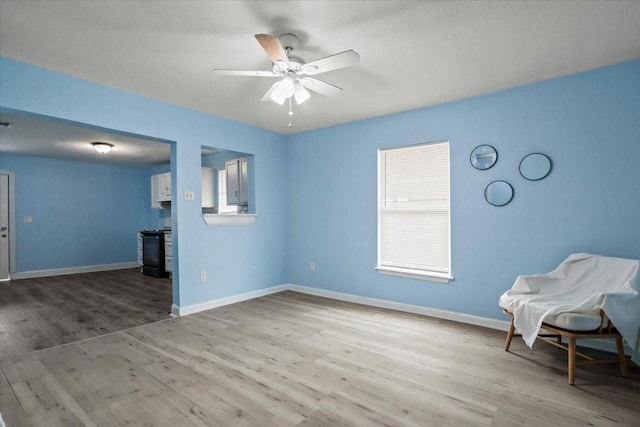 unfurnished room with ceiling fan and light wood-type flooring