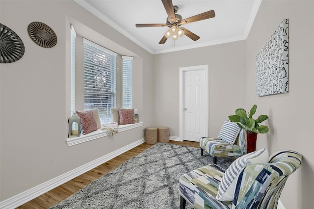 sitting room with crown molding, ceiling fan, and hardwood / wood-style floors