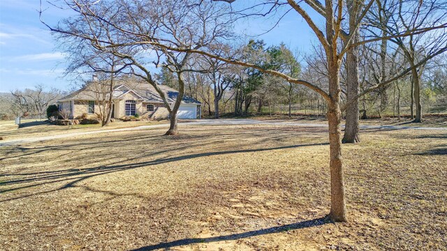 ranch-style home featuring a front lawn and a garage