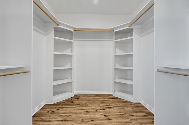 walk in closet featuring hardwood / wood-style flooring