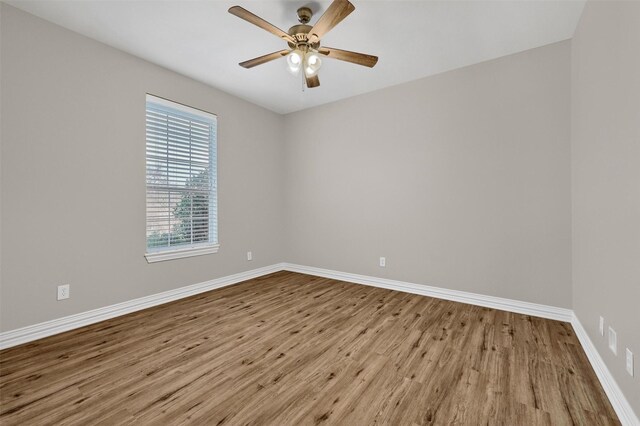 spare room featuring light hardwood / wood-style floors and ceiling fan