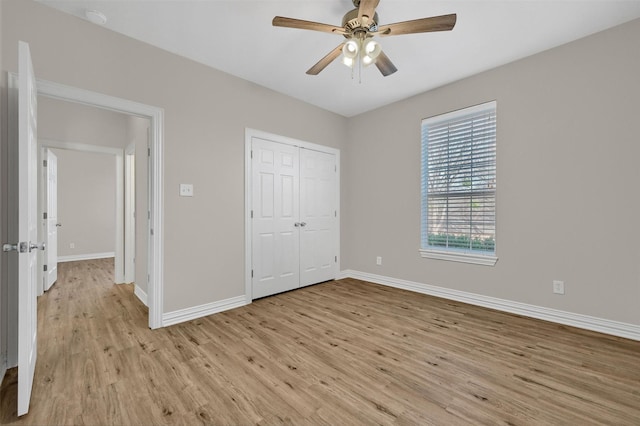 unfurnished bedroom featuring light hardwood / wood-style flooring, a closet, and ceiling fan