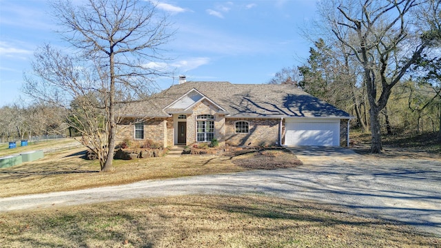 view of front of house featuring a garage and a front yard