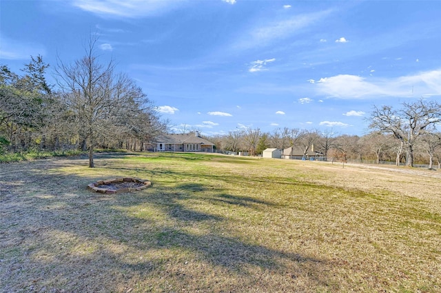 view of yard with a storage unit and a fire pit