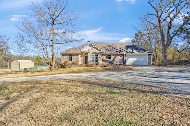 single story home with a garage and a front lawn