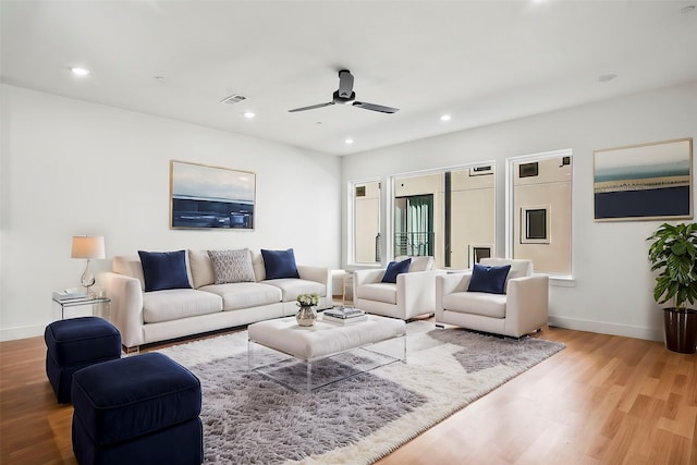 living room with ceiling fan and wood-type flooring