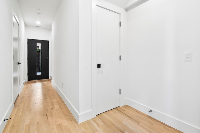 hallway with light hardwood / wood-style flooring