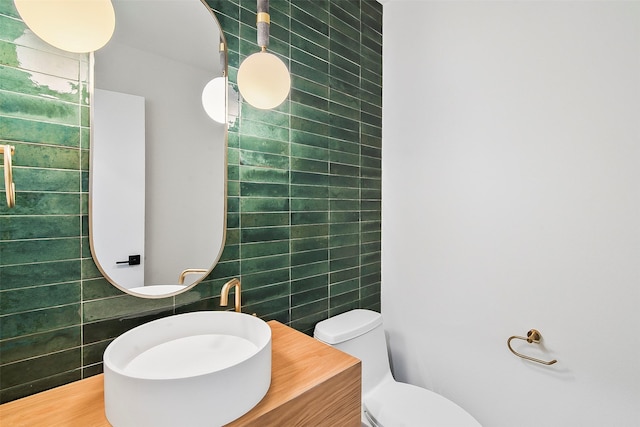 bathroom featuring tile walls, toilet, and vanity