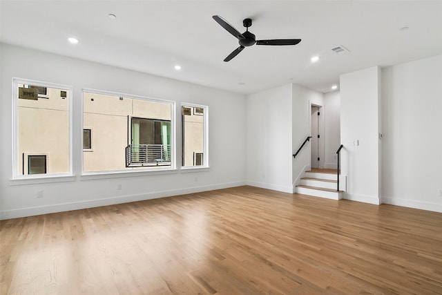 unfurnished living room featuring ceiling fan and light wood-type flooring