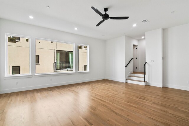 kitchen featuring light hardwood / wood-style floors, a center island with sink, stainless steel range oven, dark brown cabinetry, and sink