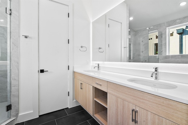 bathroom featuring an enclosed shower, vanity, and tile patterned flooring