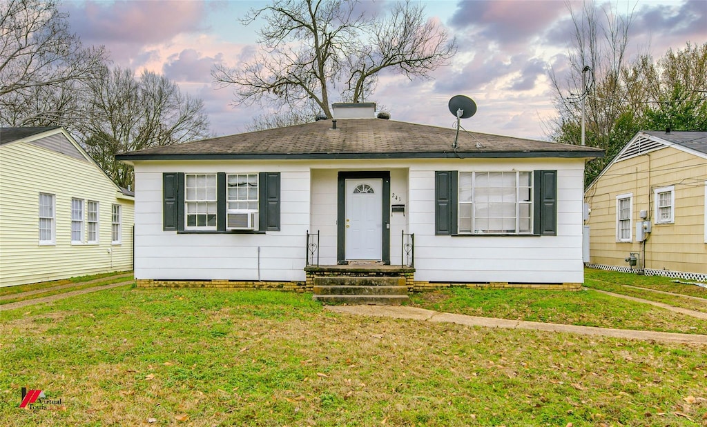 view of front of house with a yard