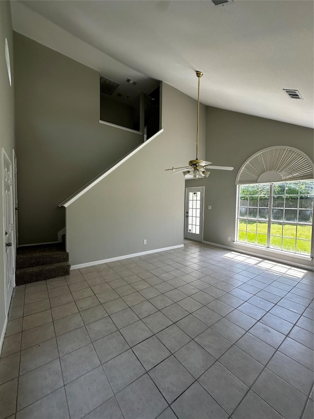 unfurnished living room featuring tile patterned floors, a ceiling fan, stairway, high vaulted ceiling, and baseboards