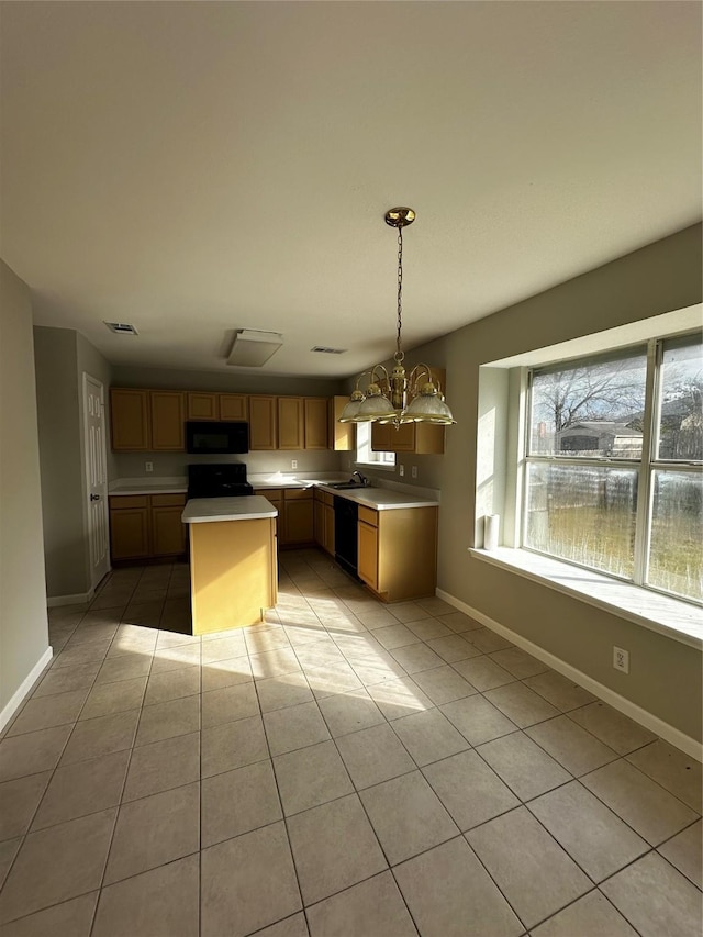 kitchen featuring decorative light fixtures, a kitchen island, black appliances, light tile patterned flooring, and an inviting chandelier