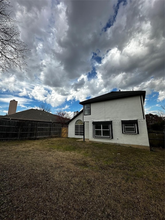 back of house featuring a yard