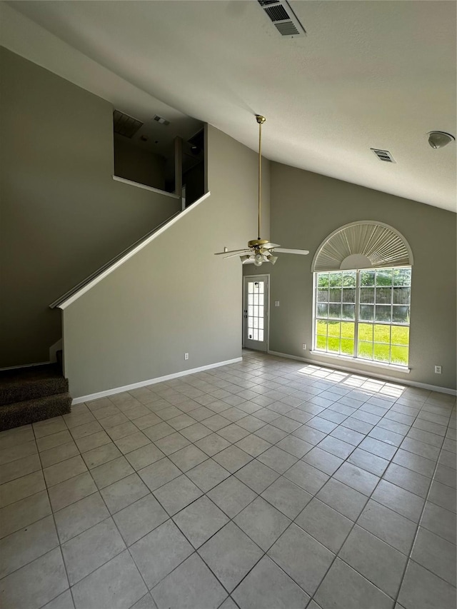 unfurnished living room featuring tile patterned flooring, a ceiling fan, baseboards, stairway, and high vaulted ceiling