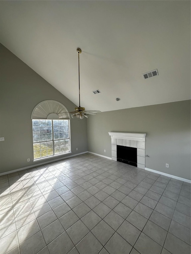 unfurnished living room featuring ceiling fan, light tile patterned floors, vaulted ceiling, and a tile fireplace