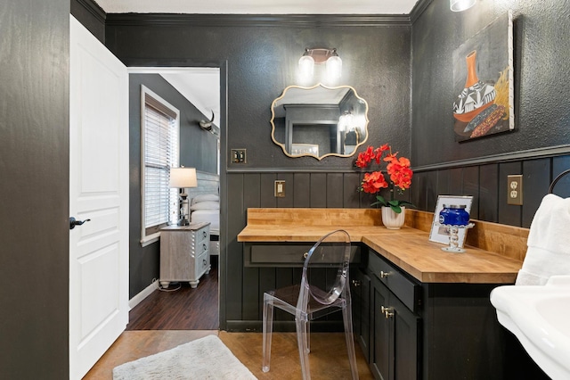 bathroom with crown molding and hardwood / wood-style floors