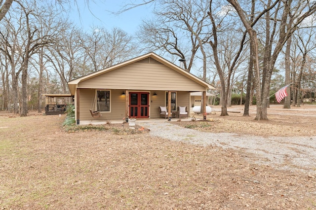 view of front of house featuring a porch and french doors