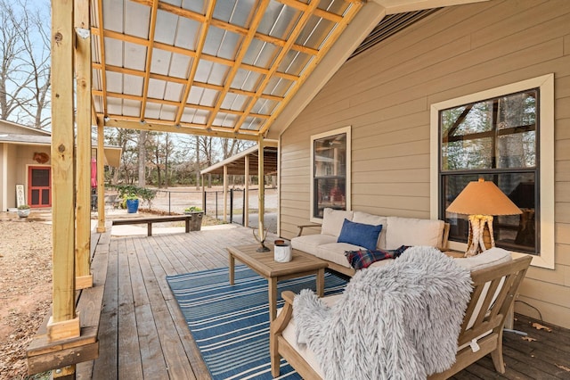 wooden terrace with an outdoor living space