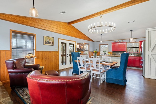 living room featuring sink, dark hardwood / wood-style flooring, a healthy amount of sunlight, and vaulted ceiling with beams