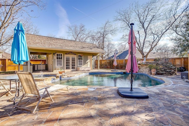 view of swimming pool with an in ground hot tub, an outdoor structure, and a patio area