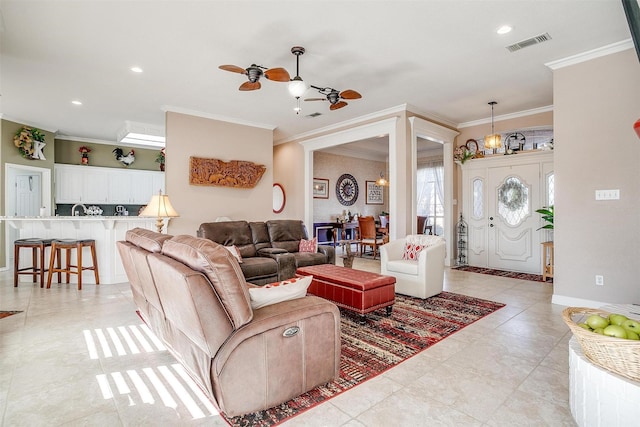 living room featuring ceiling fan and ornamental molding