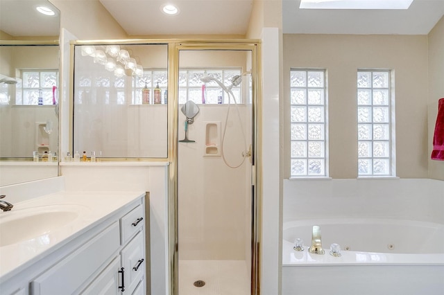 bathroom featuring a wealth of natural light, vanity, and shower with separate bathtub