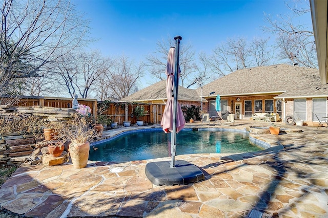 view of swimming pool featuring a patio area and a hot tub