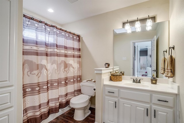 bathroom with toilet and vanity