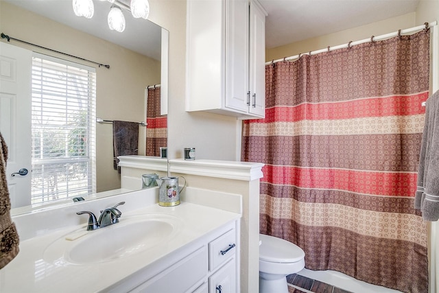 bathroom featuring toilet and vanity